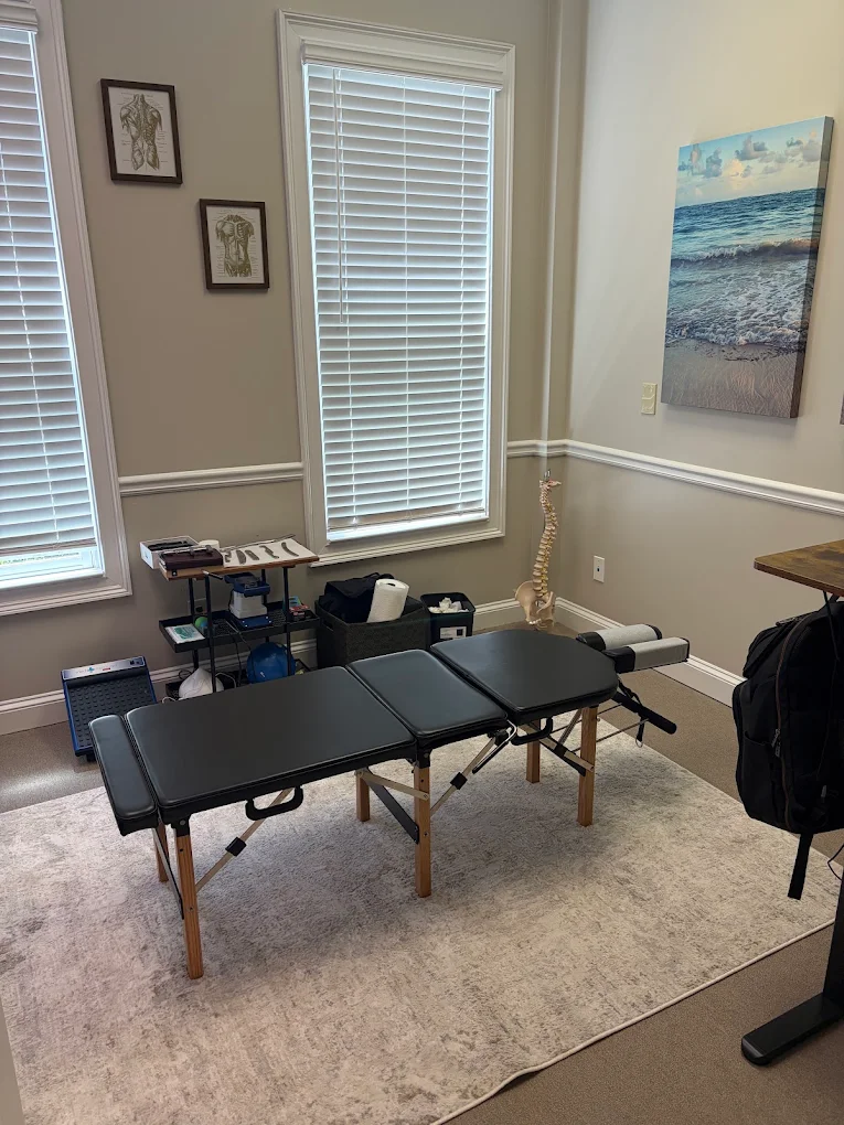 Clean, uncluttered chiropractic treatment room with a single table